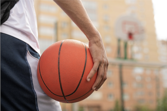 Photo: close up photo of someone holding a basketball
