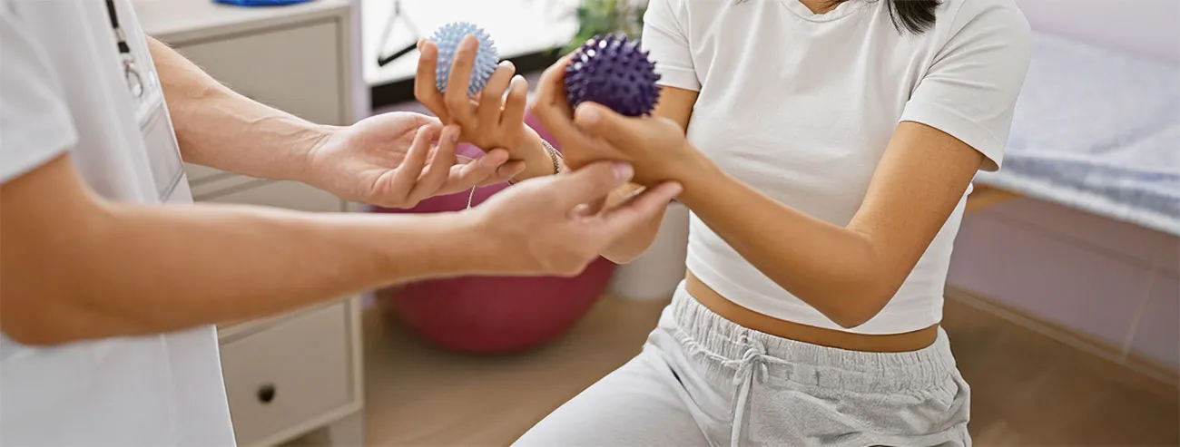 therapist helping with hand exercise