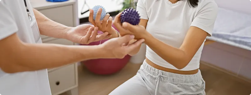 therapist helping with hand exercise