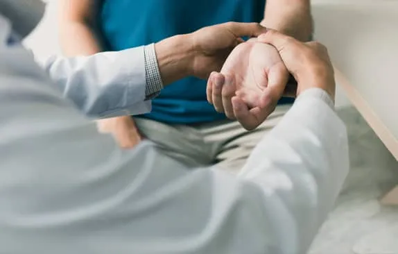 Photo: Doctor looking at patient's wrist